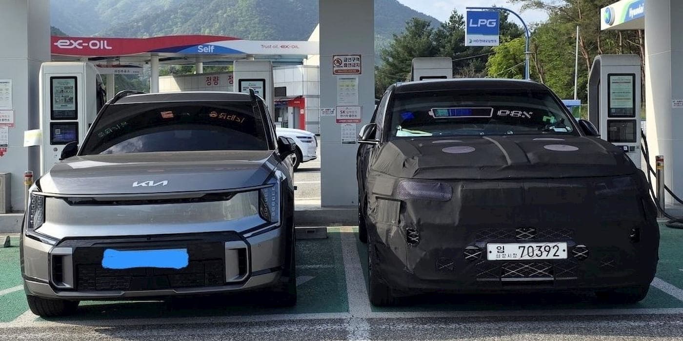 The Genesis GV90 looks huge charging next to the Kia EV9